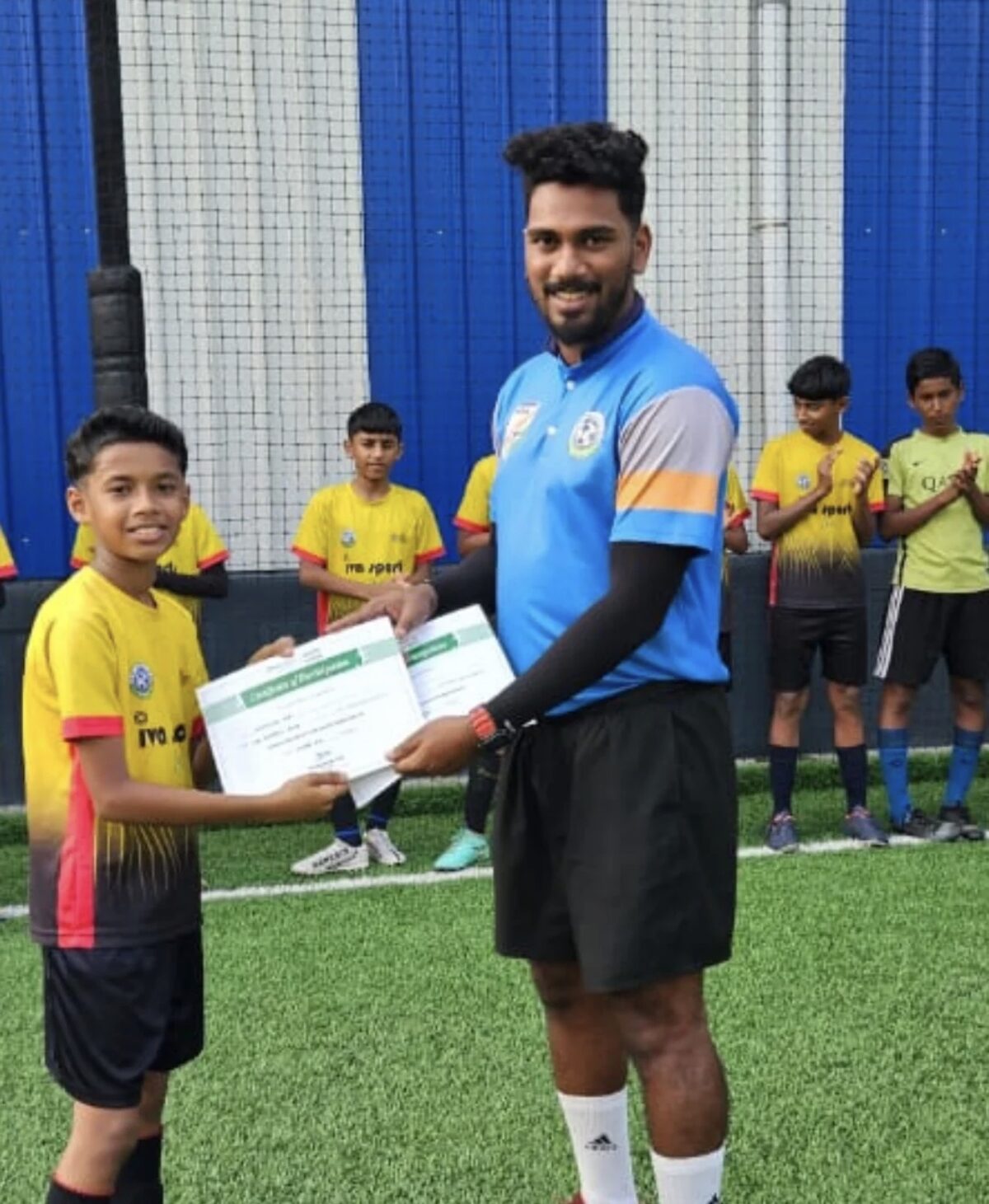Young player receiving a certificate